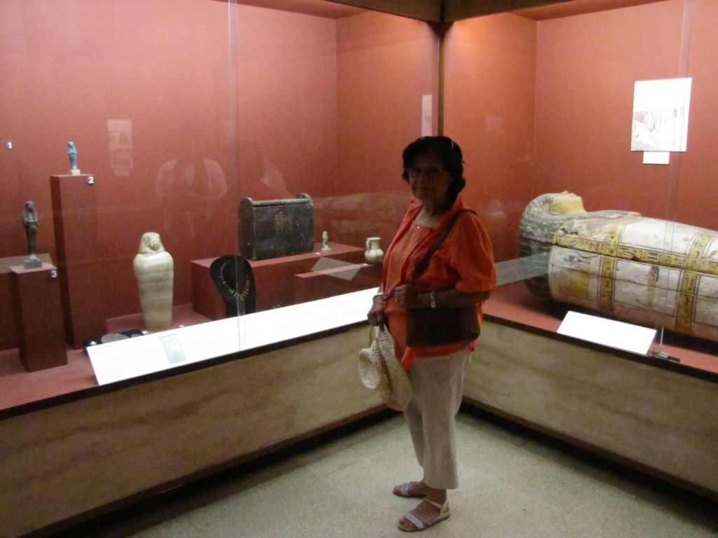 Gloria in front of an artefact display case