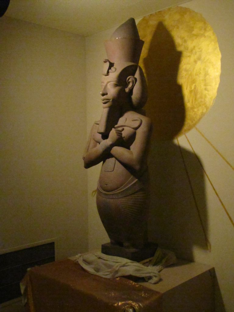 Photograph of a stone Sculpture of a Pharaoh figure.