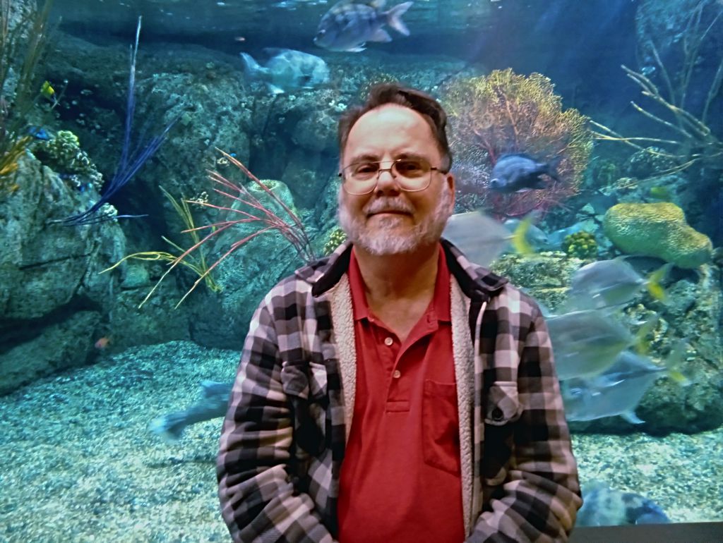 Photo of me, Kurt, in front of a fish tank.